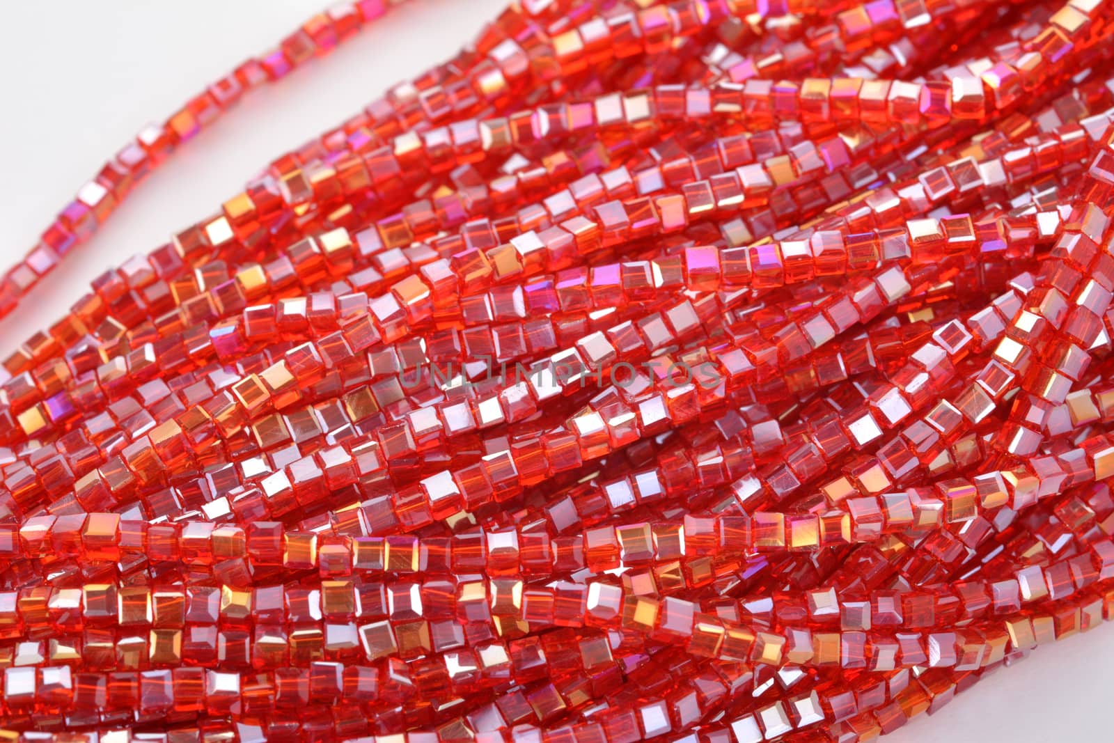 Beautiful Red scarlet, ruby Glass Sparkle Crystal Isoalted Beads on white background. Use for diy beaded jewelry. Space for text