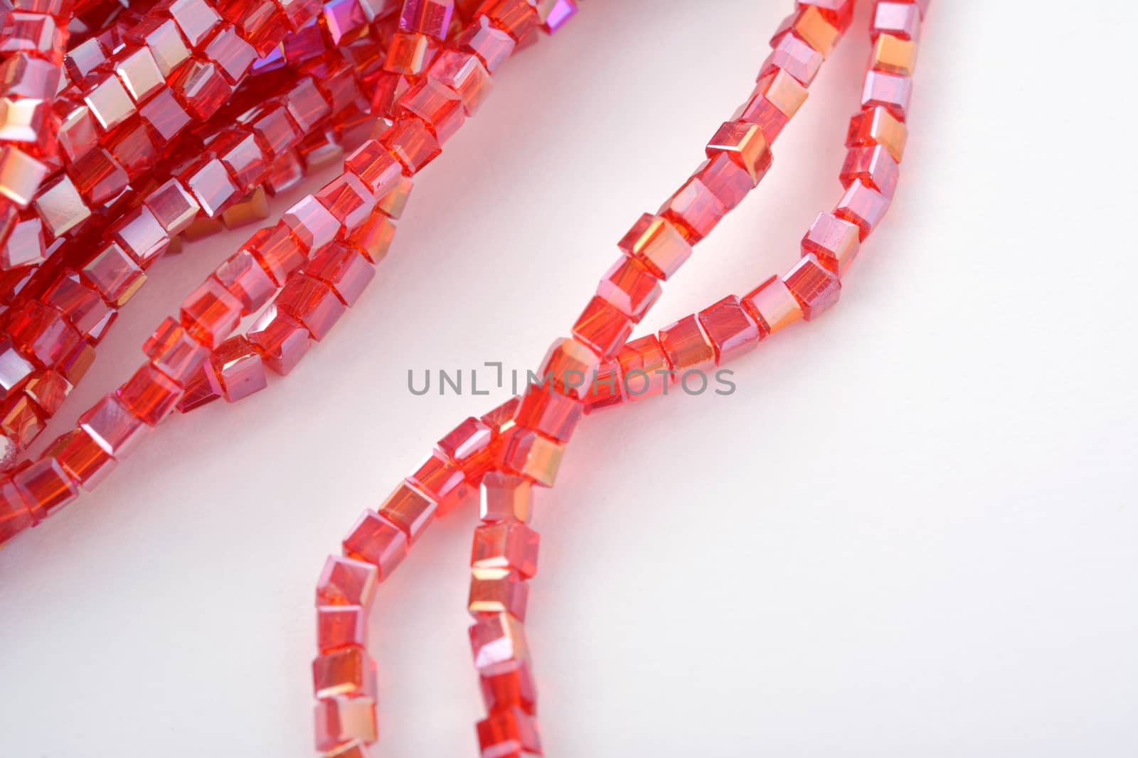Beautiful Red scarlet, ruby Glass Sparkle Crystal Isoalted Beads on white background. Use for diy beaded jewelry. Space for text