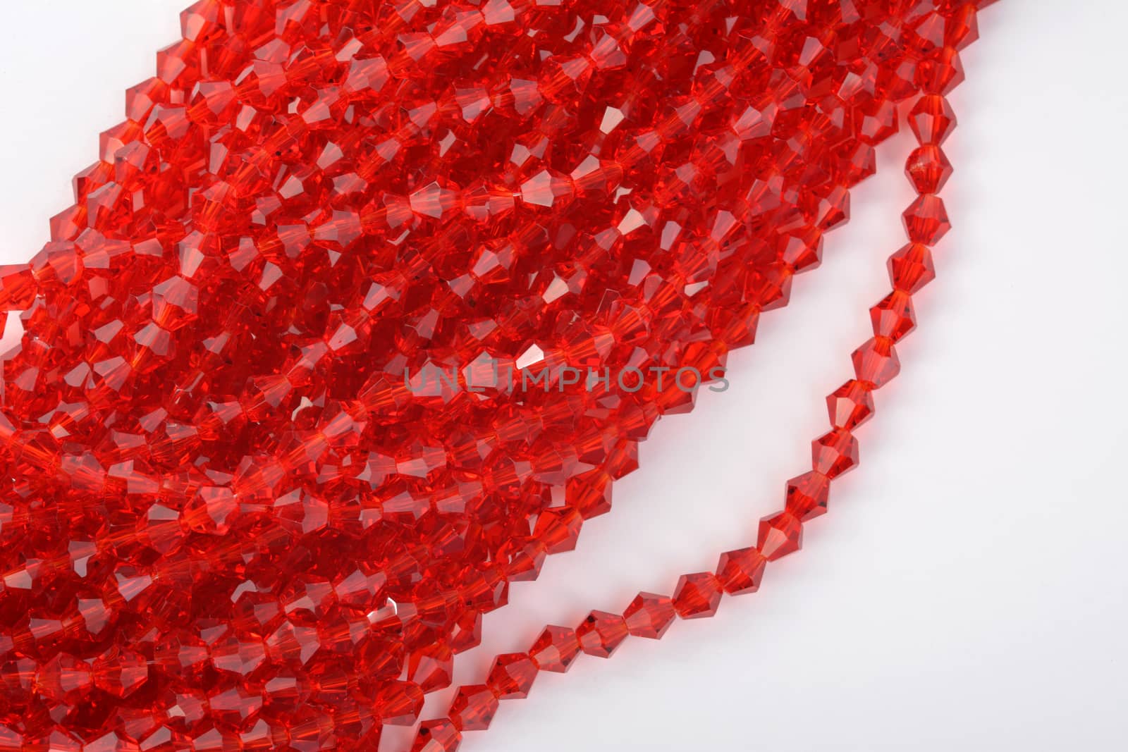 Beautiful Red scarlet, ruby Glass Sparkle Crystal Isoalted Beads on white background. Use for diy beaded jewelry. Space for text