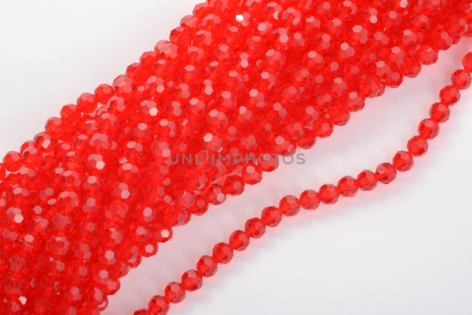 Beautiful Red scarlet, ruby Glass Sparkle Crystal Isoalted Beads on white background. Use for diy beaded jewelry. Space for text