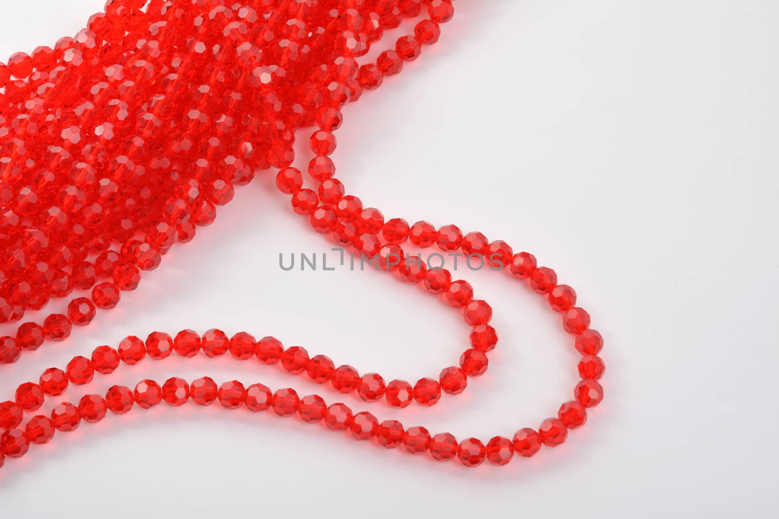 Beautiful Red scarlet, ruby Glass Sparkle Crystal Isoalted Beads on white background. Use for diy beaded jewelry. Space for text