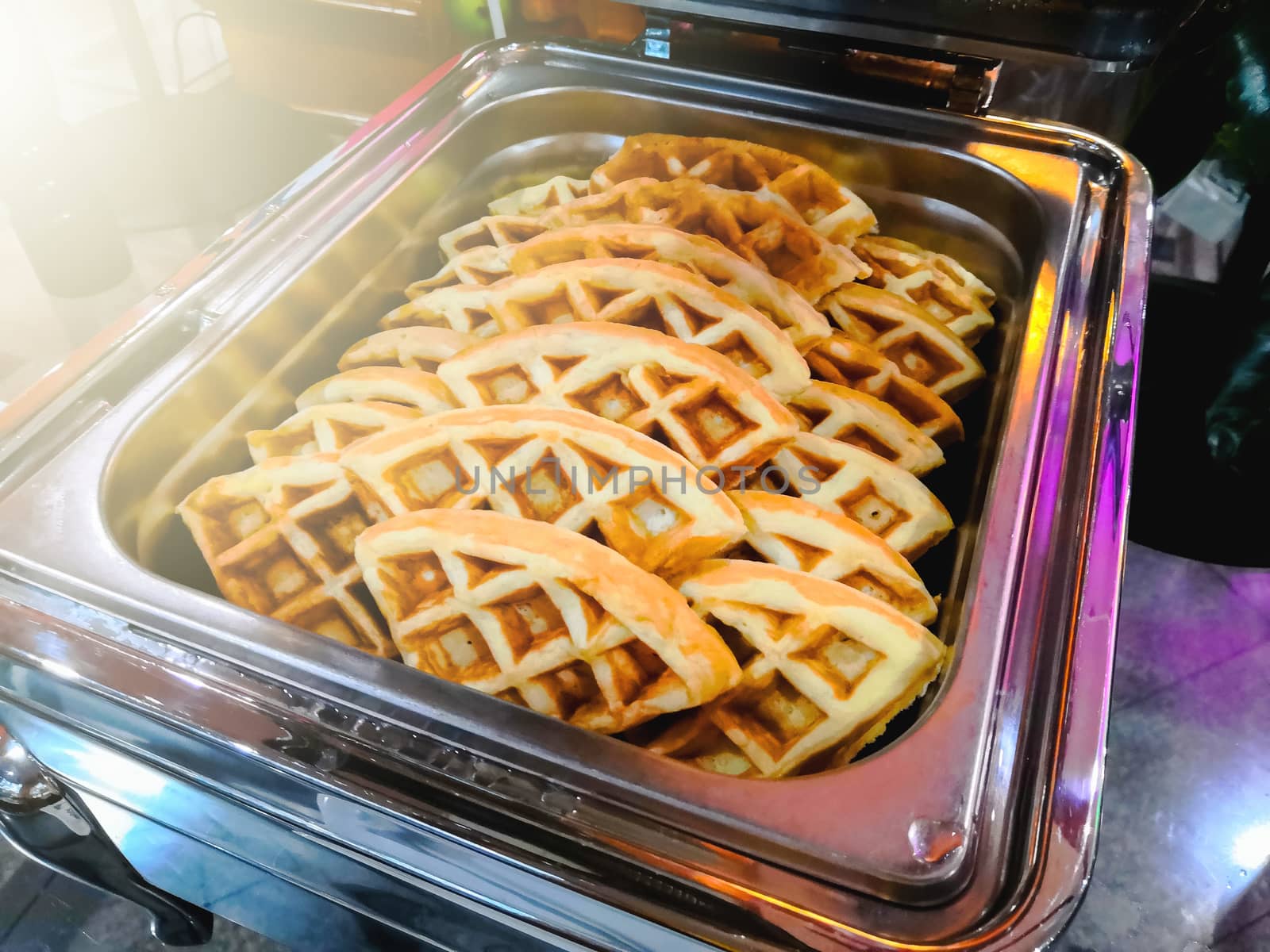 Waffles are prepared for customers in restaurants.