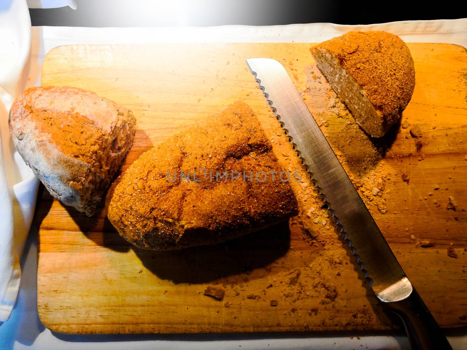 Whole grain bread on cutting board with knife