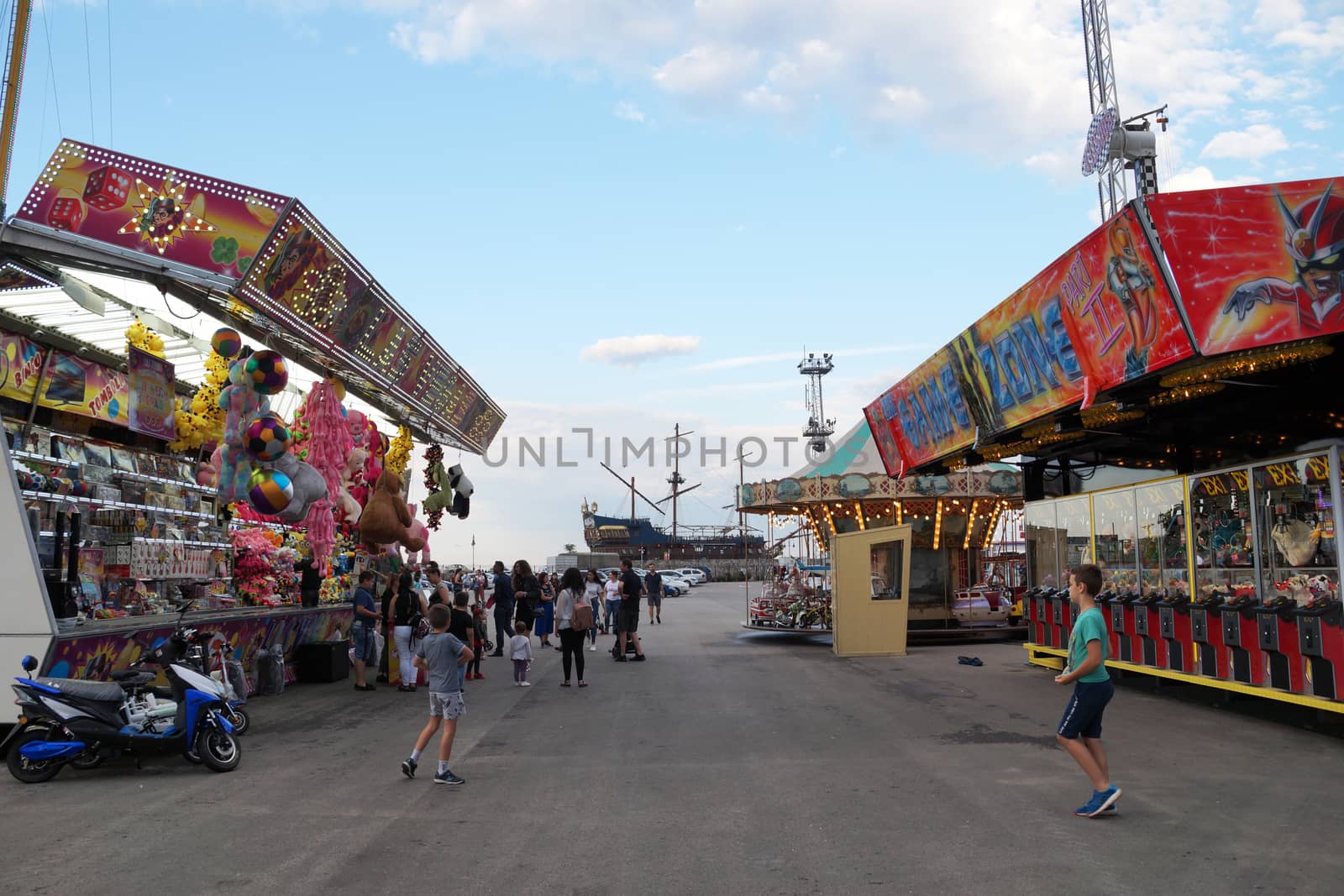 city amusement park with attractions in summer by Annado