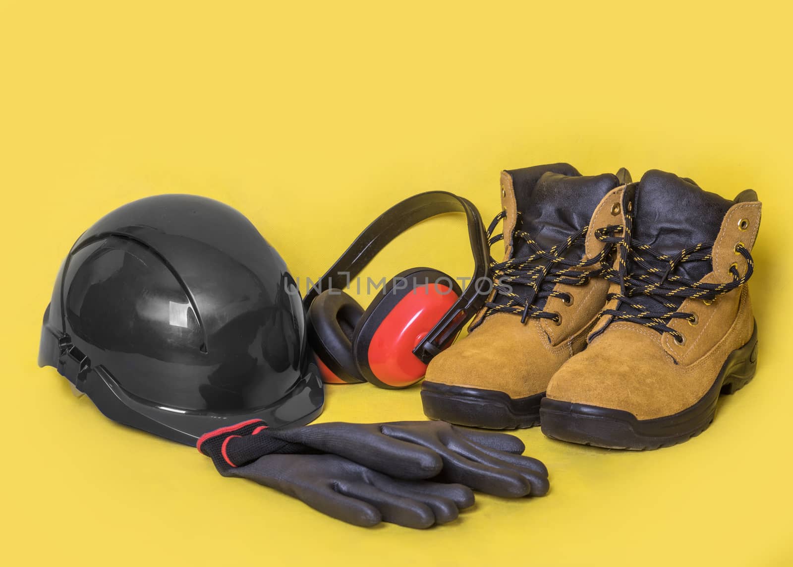 Construction Personal protective equipment on yellow background by Iryna_Melnyk