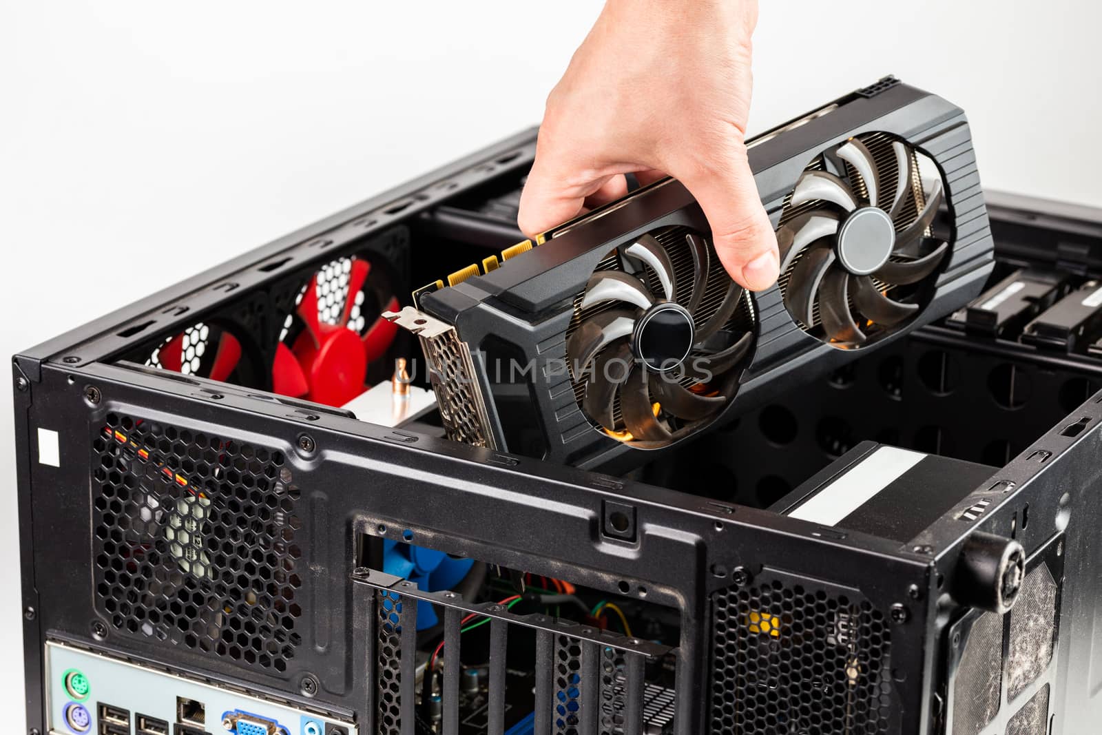 hand plugging a video card while maintenance personal computer hardware with selective focus closeup