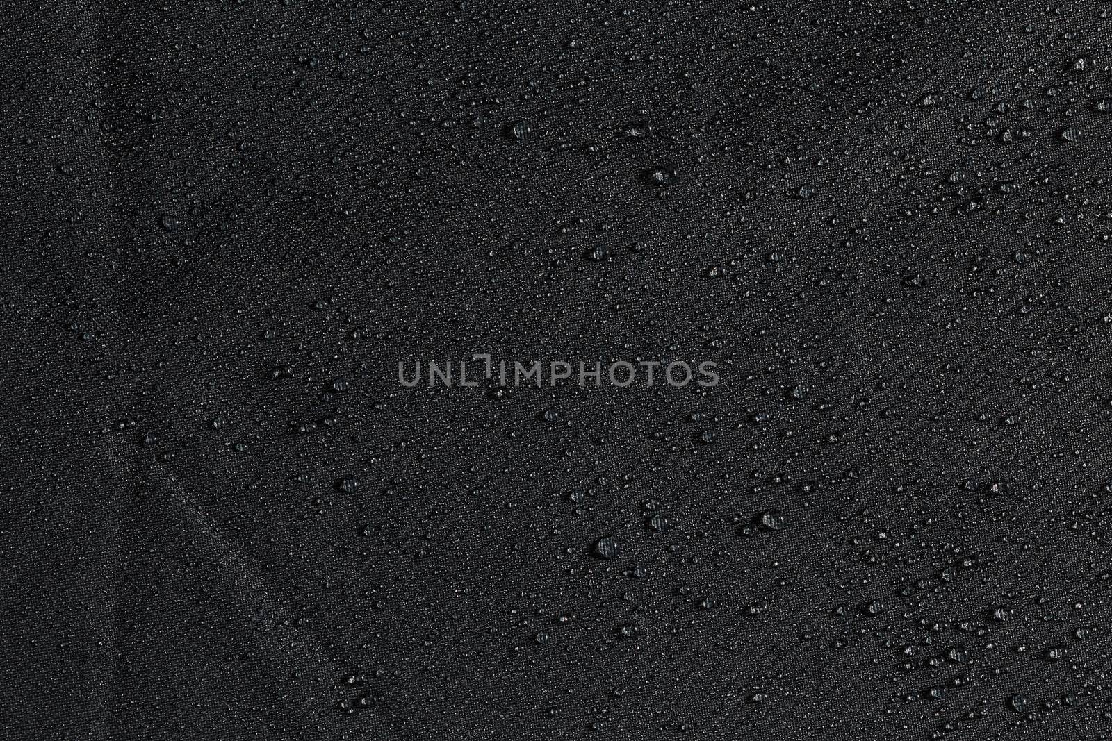 dark gray waterproof hydrophobic flat cloth closeup with rain drops background by z1b