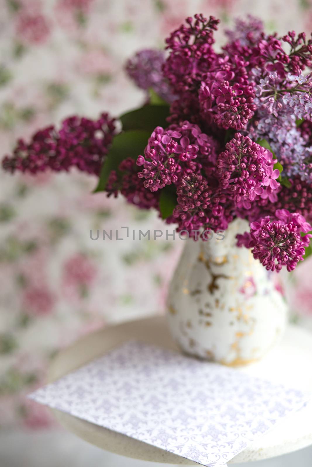 Bouquet of violet lilac in a vintage shabby vase. Still life with blooming branches of lilac in vases. Greeting card mock up.