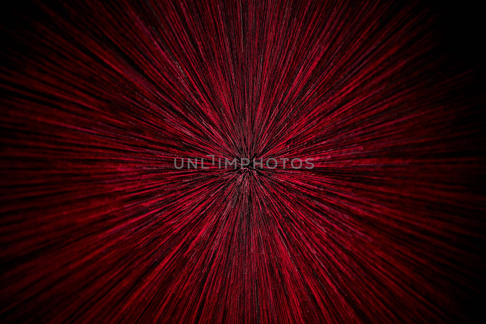 natural lens zoom explosion radial blurred red particles on black background with selective focus.