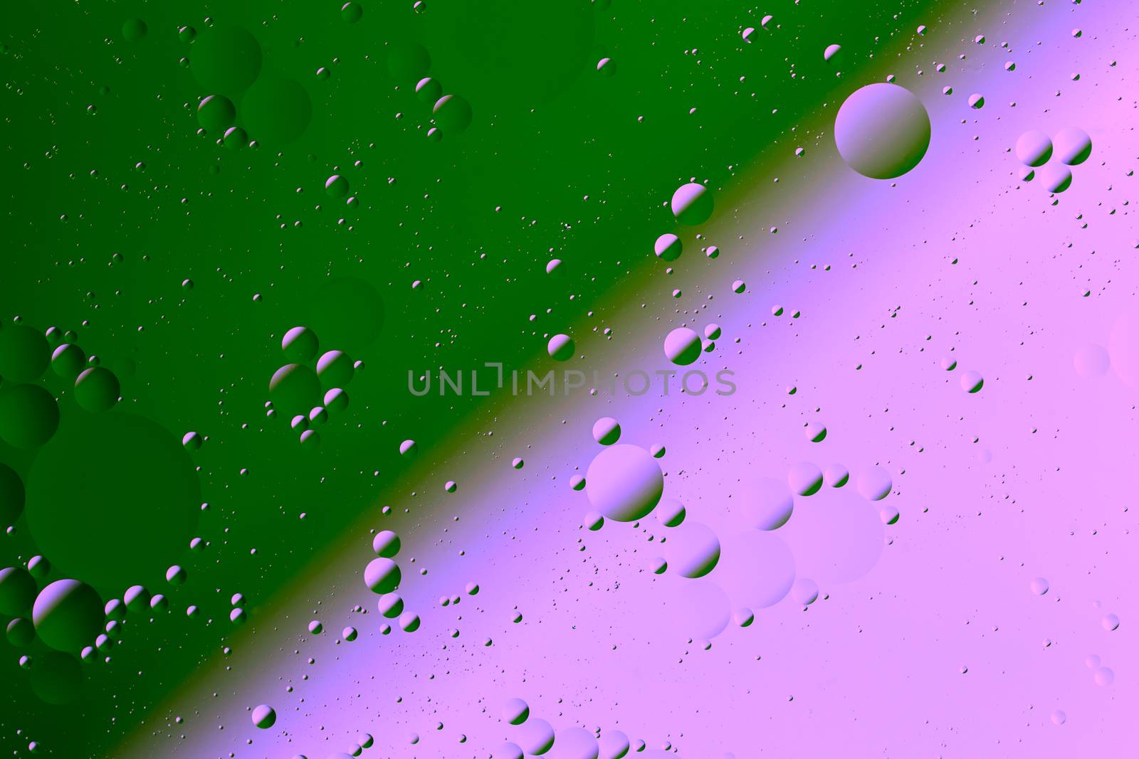 Oil on water flat colorful duotone macro abstract background photographic image. Mint green and plastic pink diagonal soft split line.