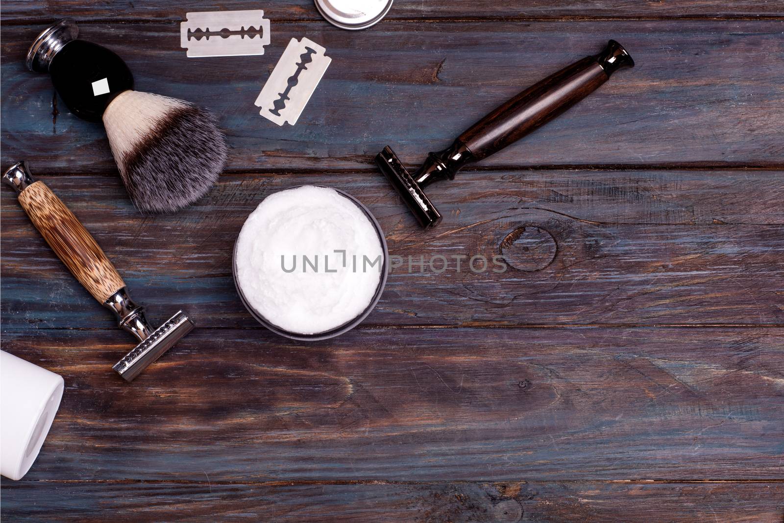 Razor, brush, perfume, blades, balsam, and shaving foam on a black background by Iryna_Melnyk