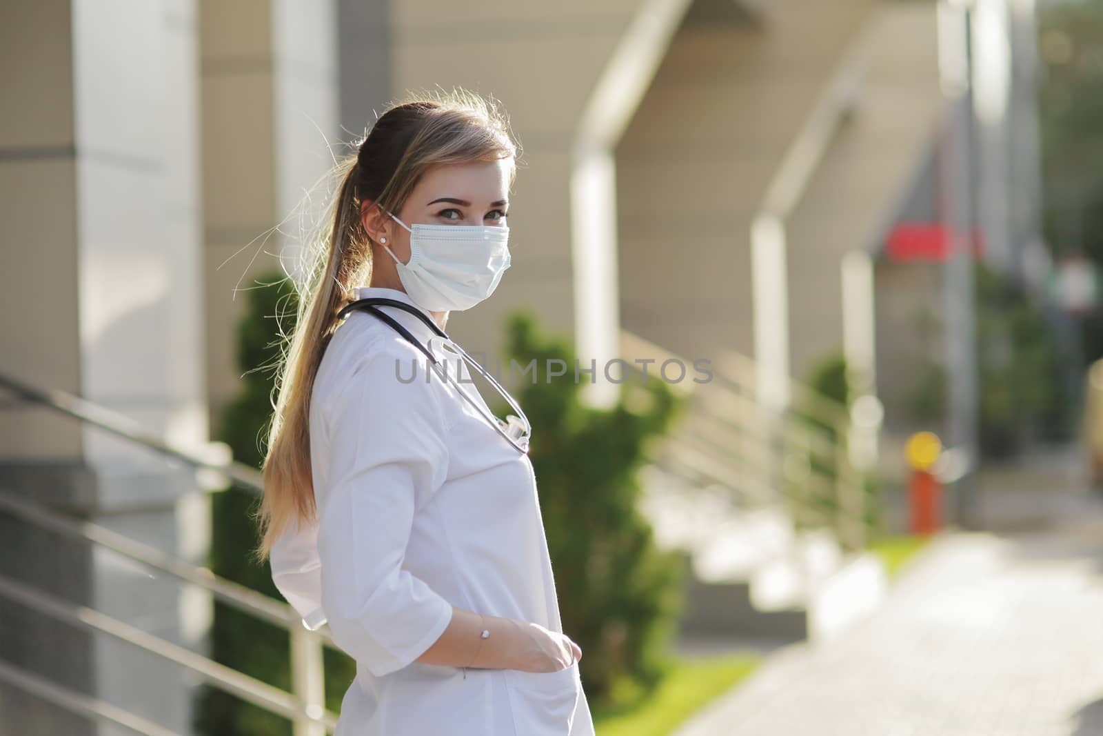 Female doctor or nurse wearing a face protective mask Covid19 healthcare concept by selinsmo