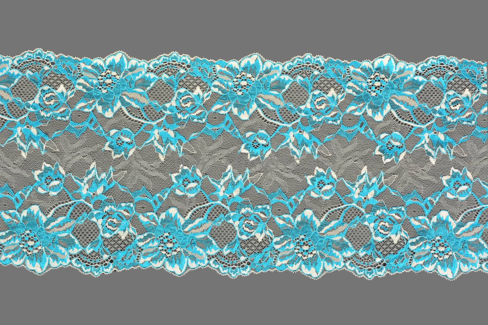 white blue color straight strip of lace fabric on gray background. Elastic silk nylon braid border. use clothes linen decoration. repeating pattern and interweaving threads. texture for websites