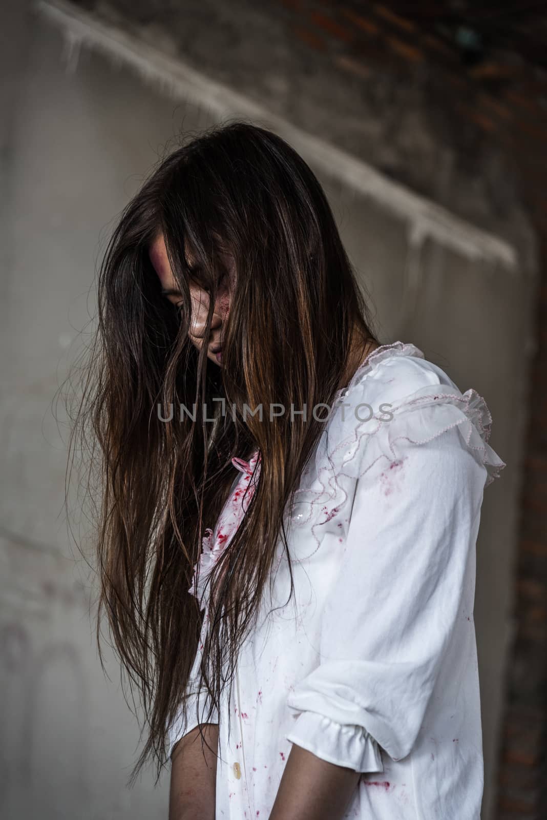 Portrait zombie woman with blood on face by Sorapop