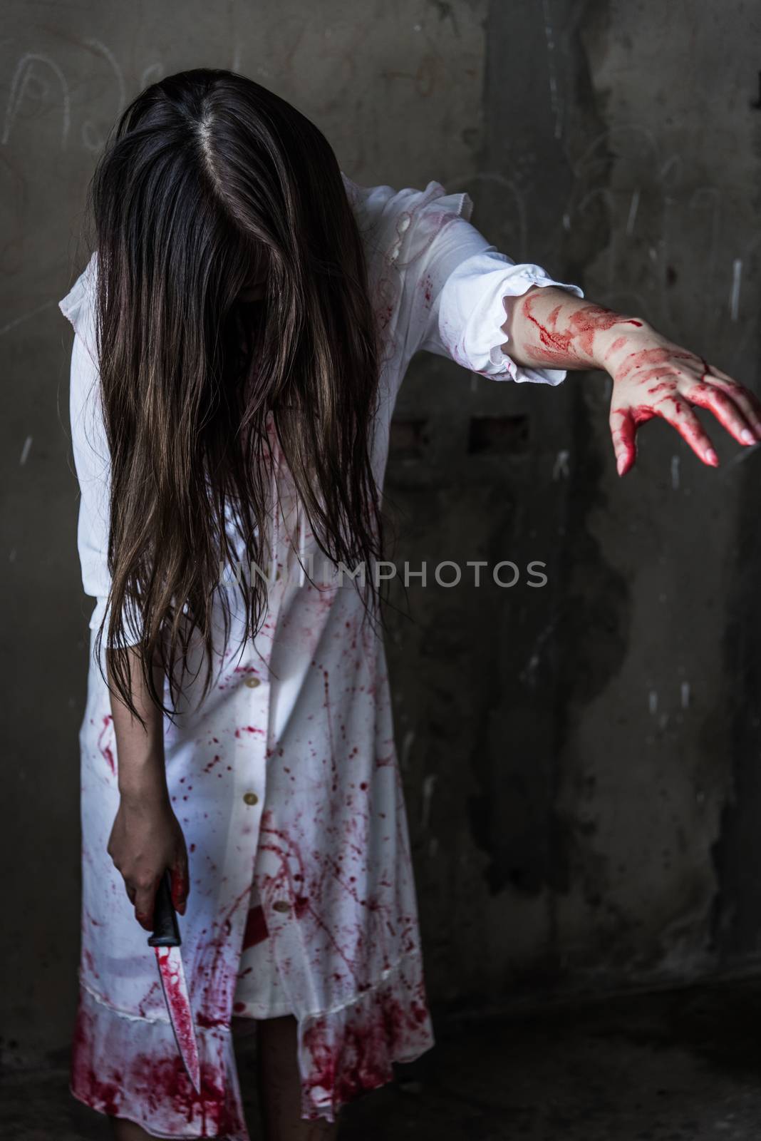 Ghost woman or Zombie holding knife reach arm by Sorapop