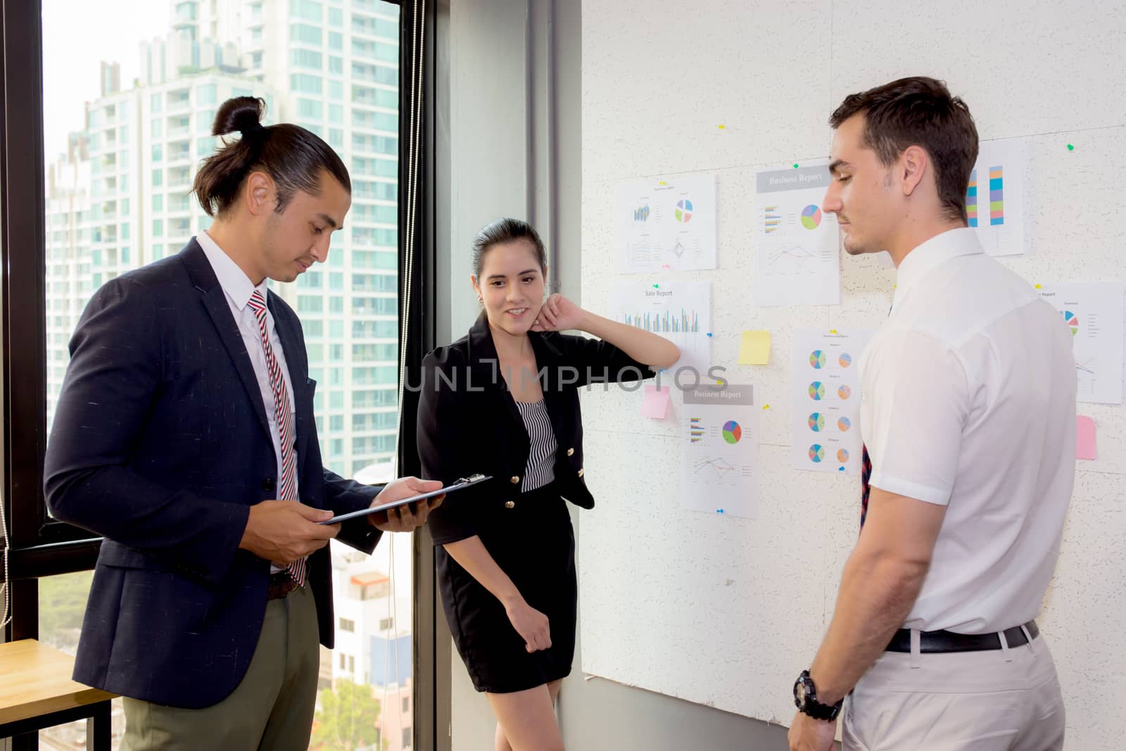 three business people in modern office looking report and analyz by nnudoo