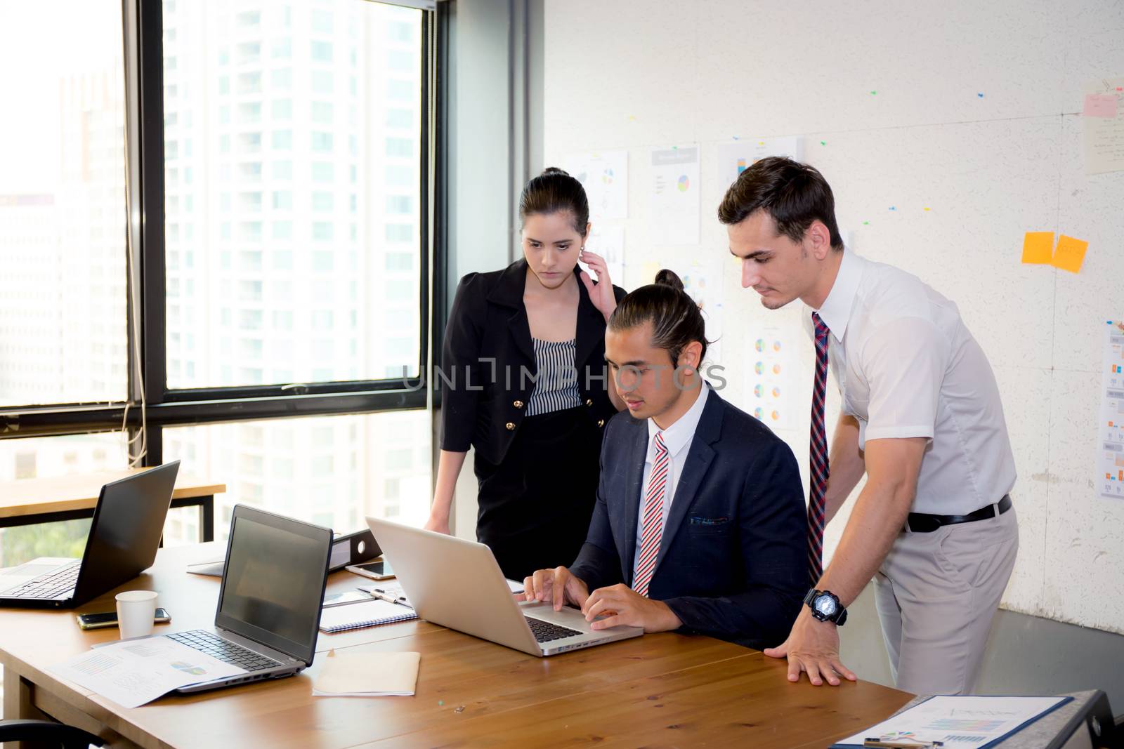 American people business team having using laptop during a meeting and presents.