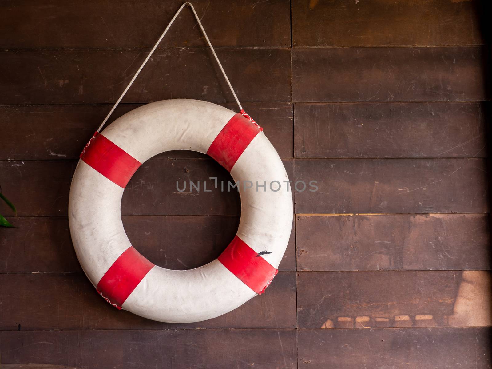 Sea lifebuoy on wooden background . Copy space for individual te by shutterbird