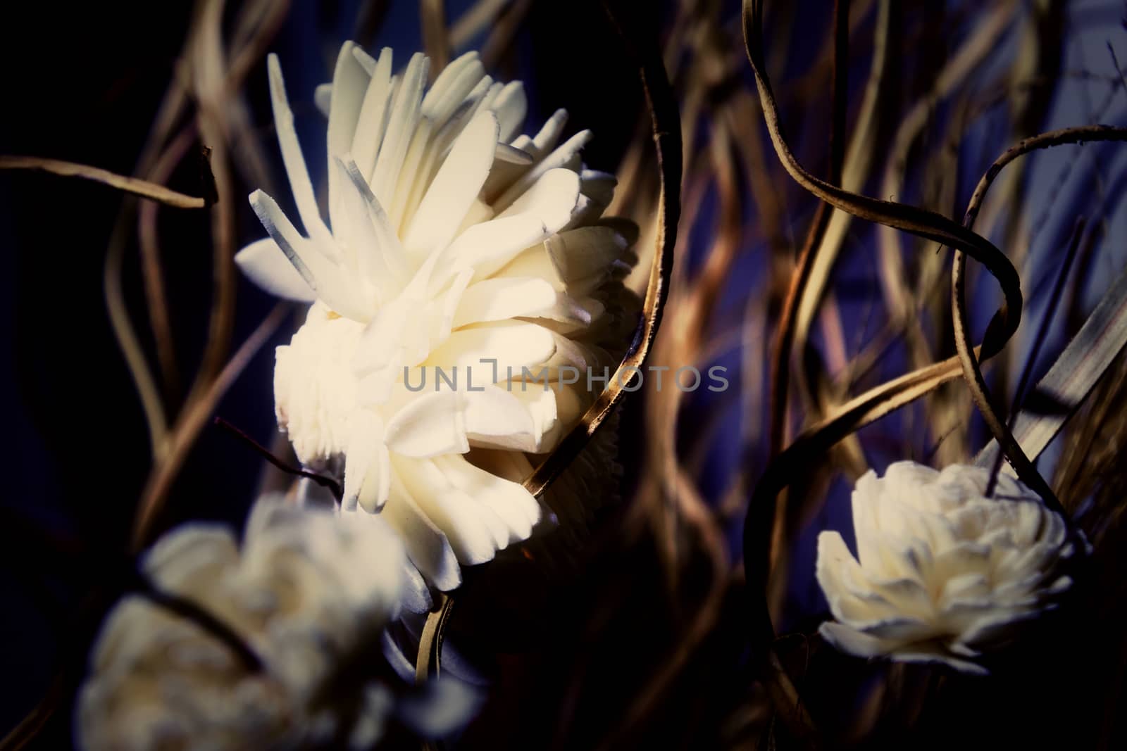 from dry straw, leaves and artificial flowers blurred background by client111