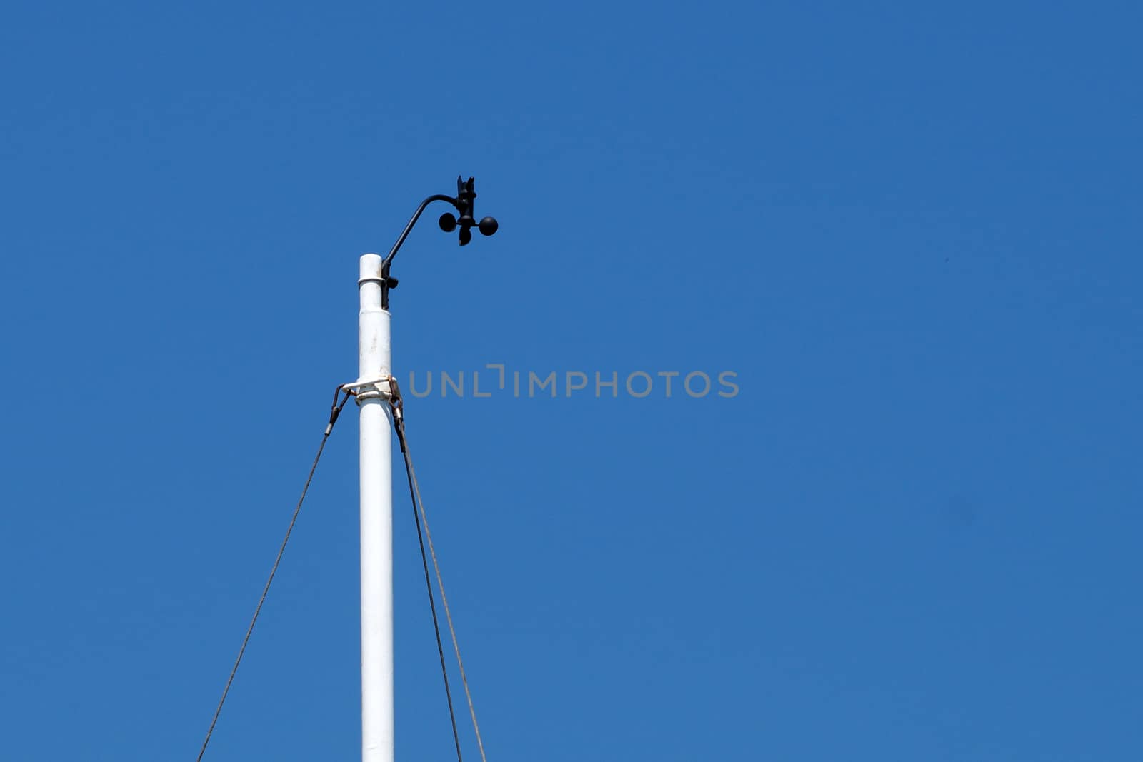 meteorological device for measuring wind speed against a blue sky close-up