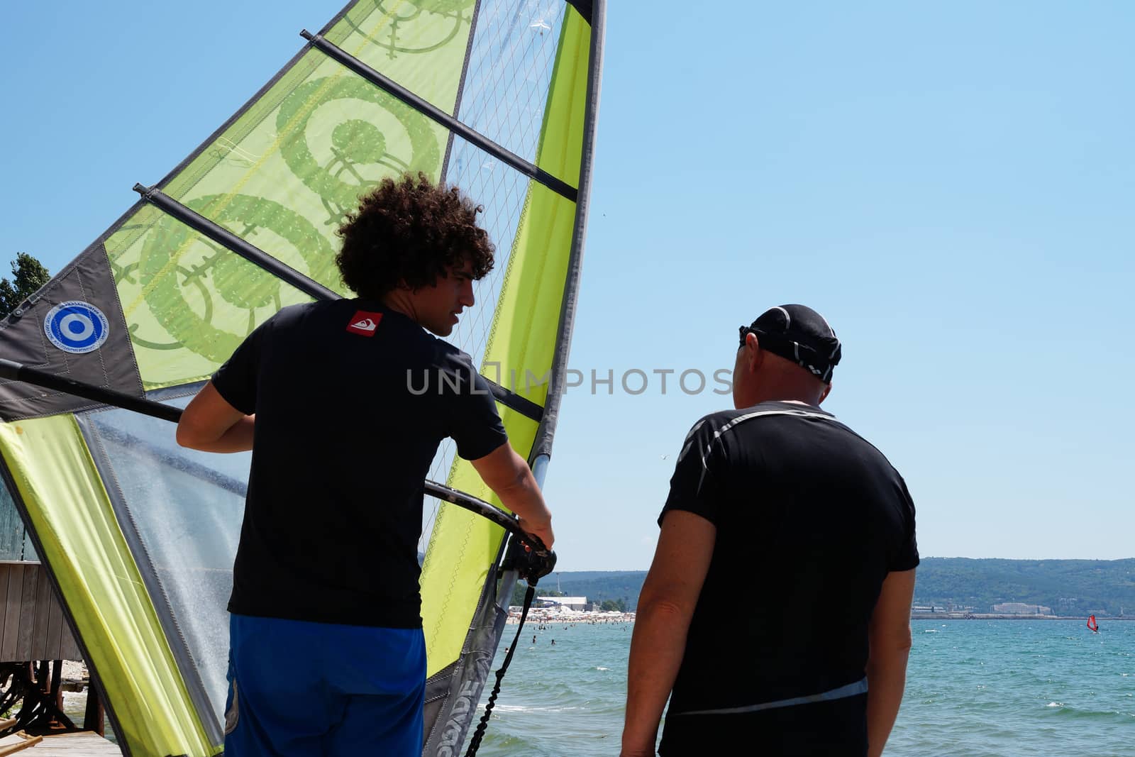 Varna, Bulgaria - July, 31,2020: two men learning to windsurf at sea