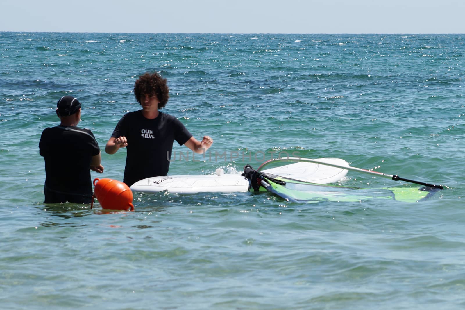 Varna, Bulgaria - July, 31,2020: two men learning to windsurf at sea