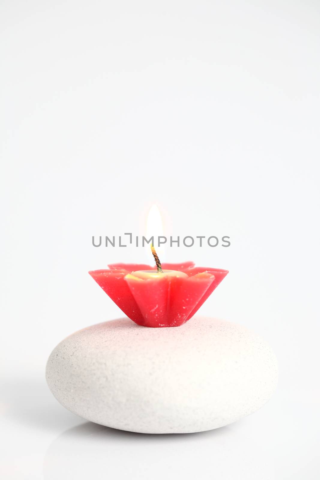 flower candles on stone isolated in white background