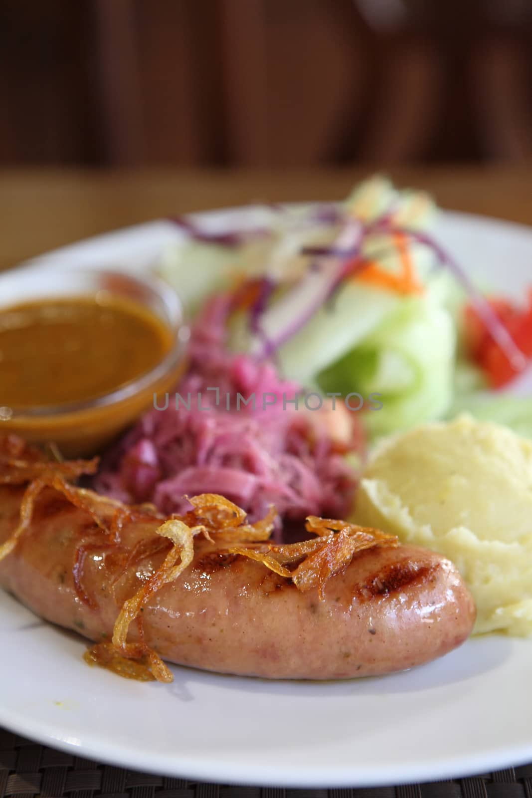 Sausage with salad on wood background