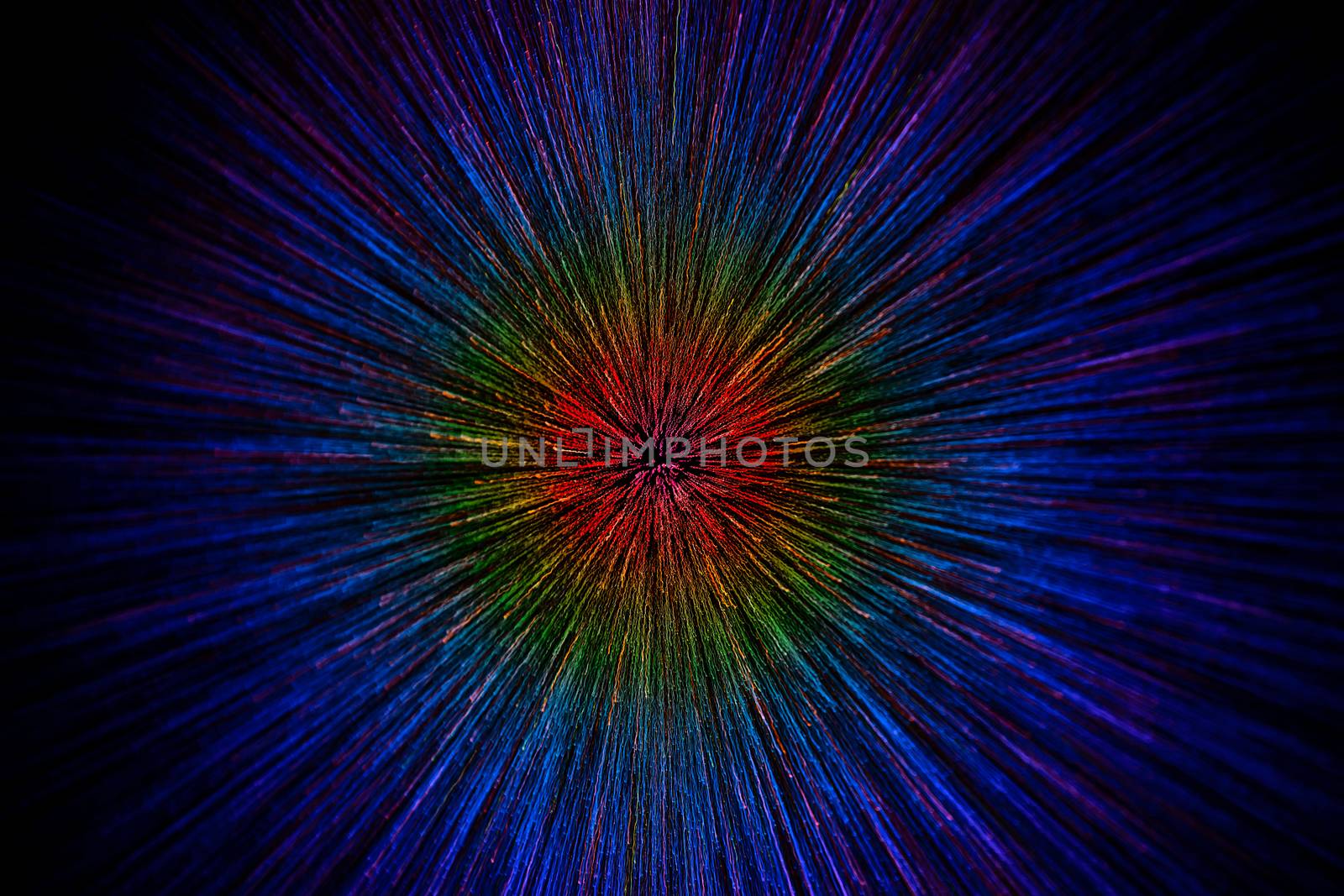 natural lens zoom explosion radial gradient color blurred dots on black background with selective focus.