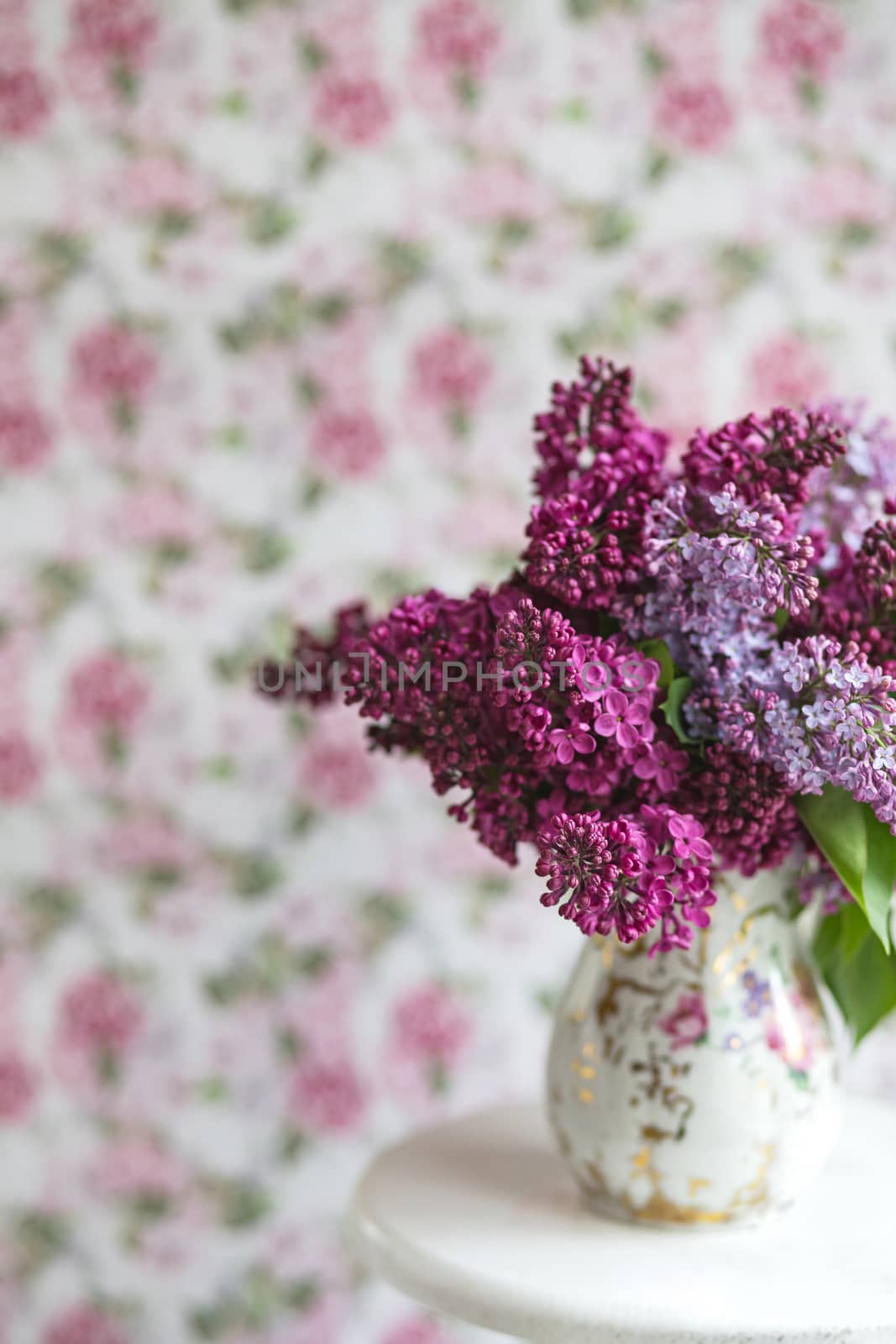 Bouquet of violet lilac in a vintage shabby vase. Still life with blooming branches of lilac in vases. Greeting card mock up.