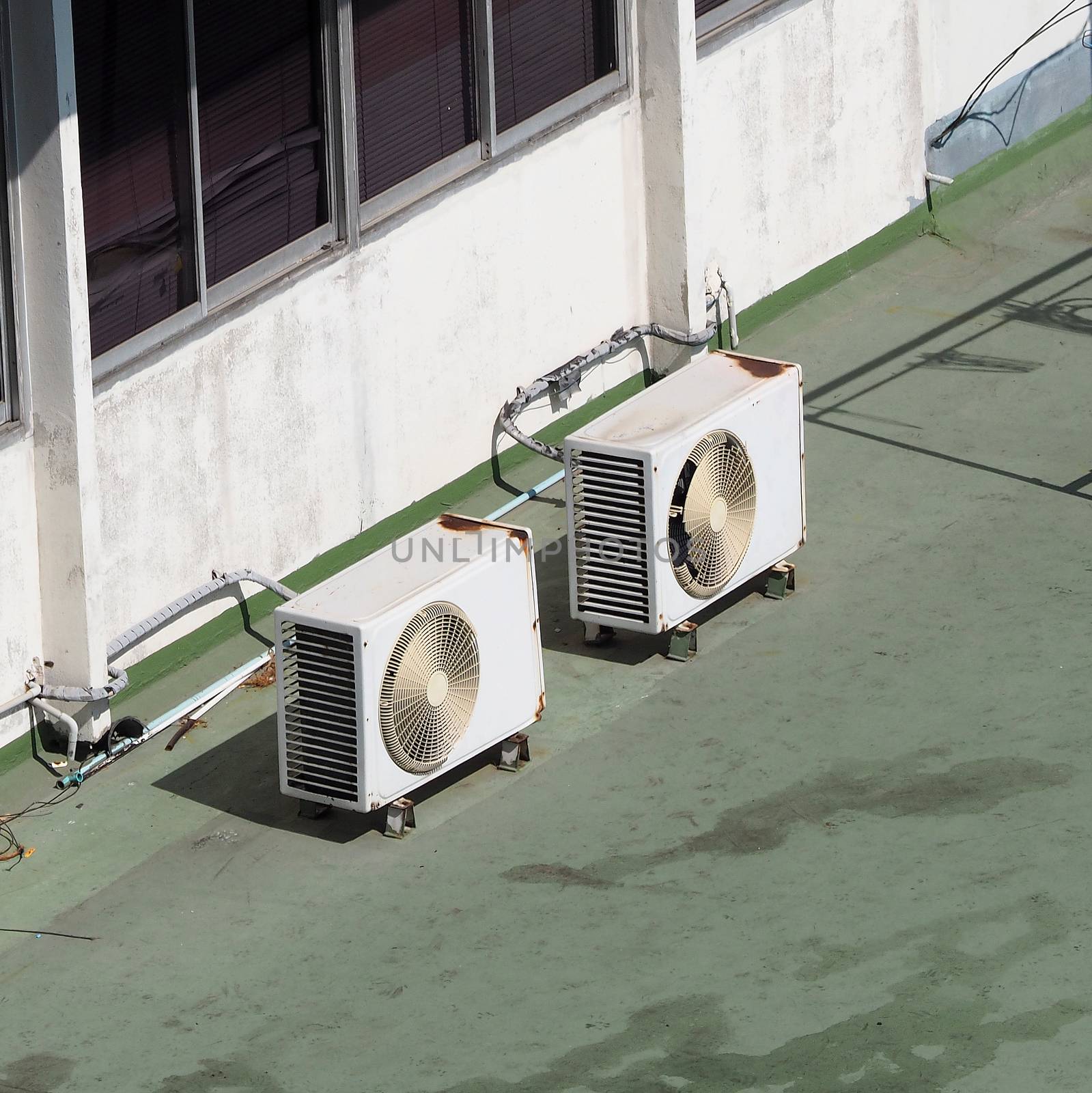 Old air conditioner Compressor on the terrace space and outdoor in summer daytime Bangkok Thailand and top view angle shot.