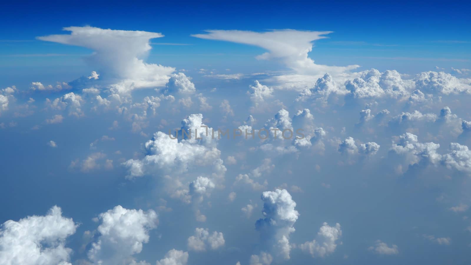White clouds on the blue sky from airplane view.