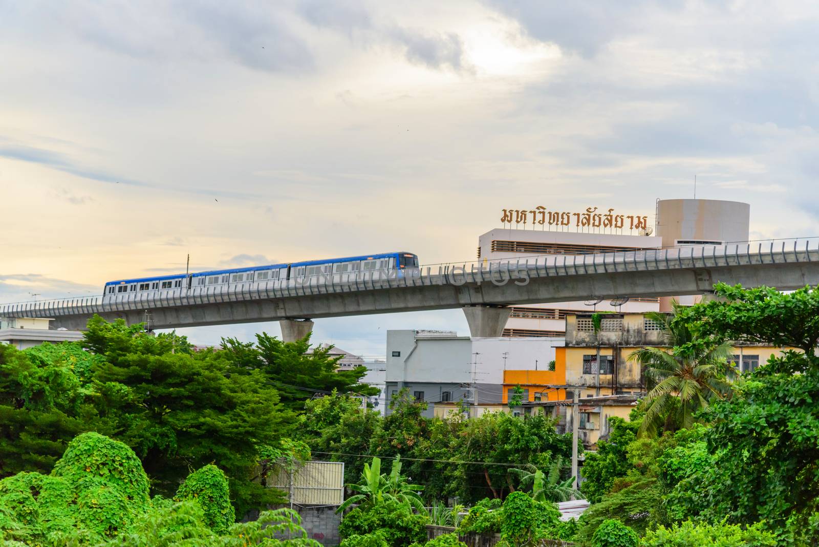 Bangkok , Thailand -  2 August, 2020 :  MRT electric skytrain with Label of Siam University in sunset time