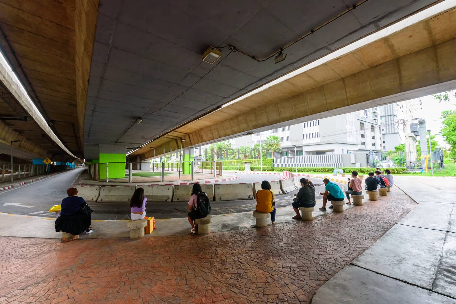 People with social distance sitting for taxi queue with new normal style