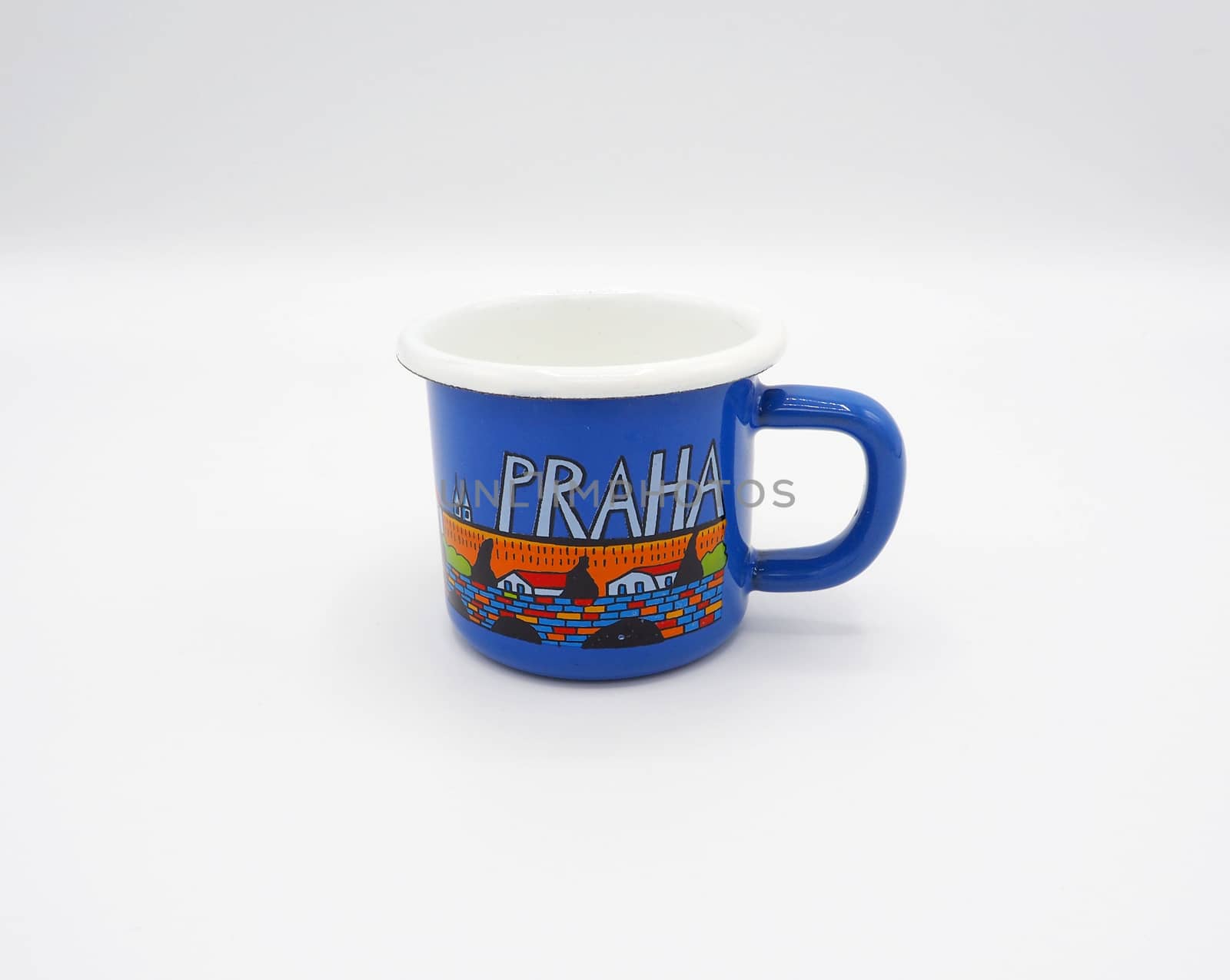 Small tiny and blue colour with hand made art souvenir coffee cup from Praque Czech Replublic and studio shot on white background.