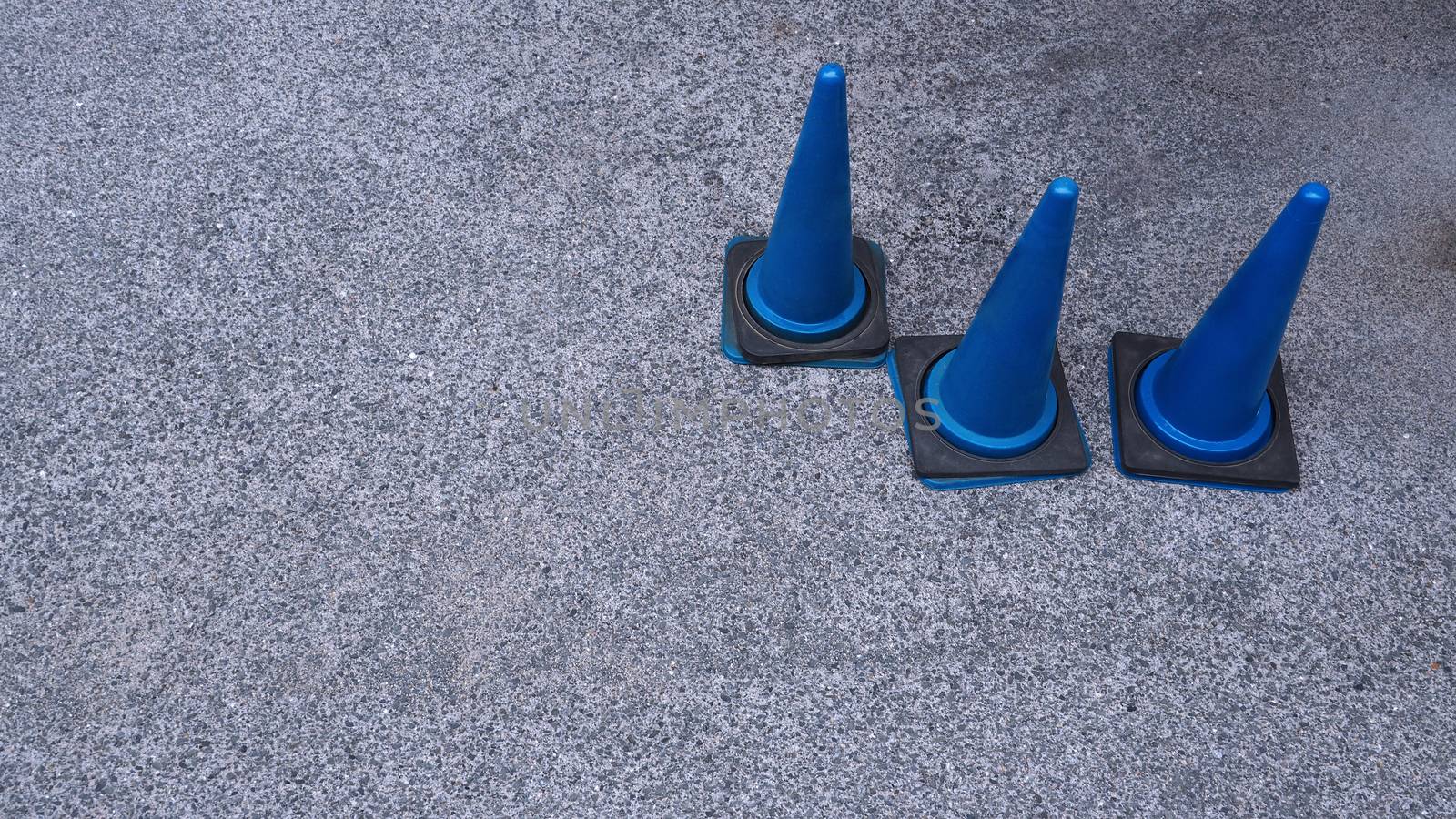 Blue color plastic material traffic cones on road by gnepphoto