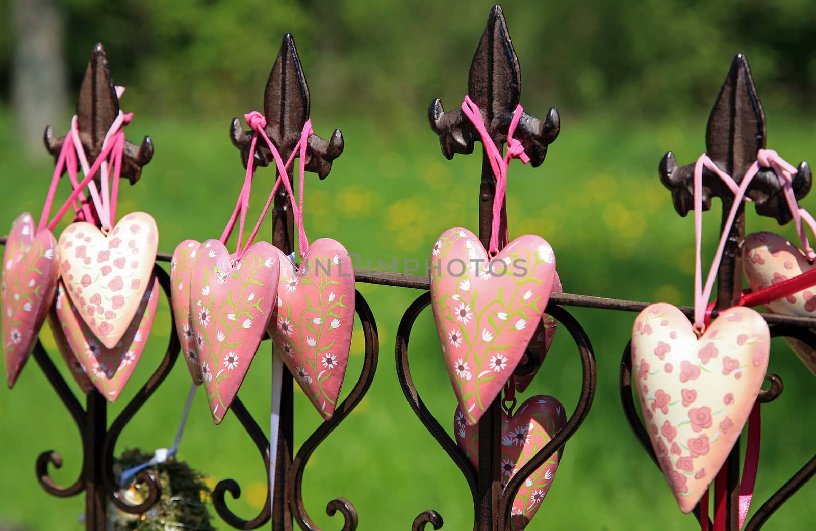 Pink hearts decorating a metal fence