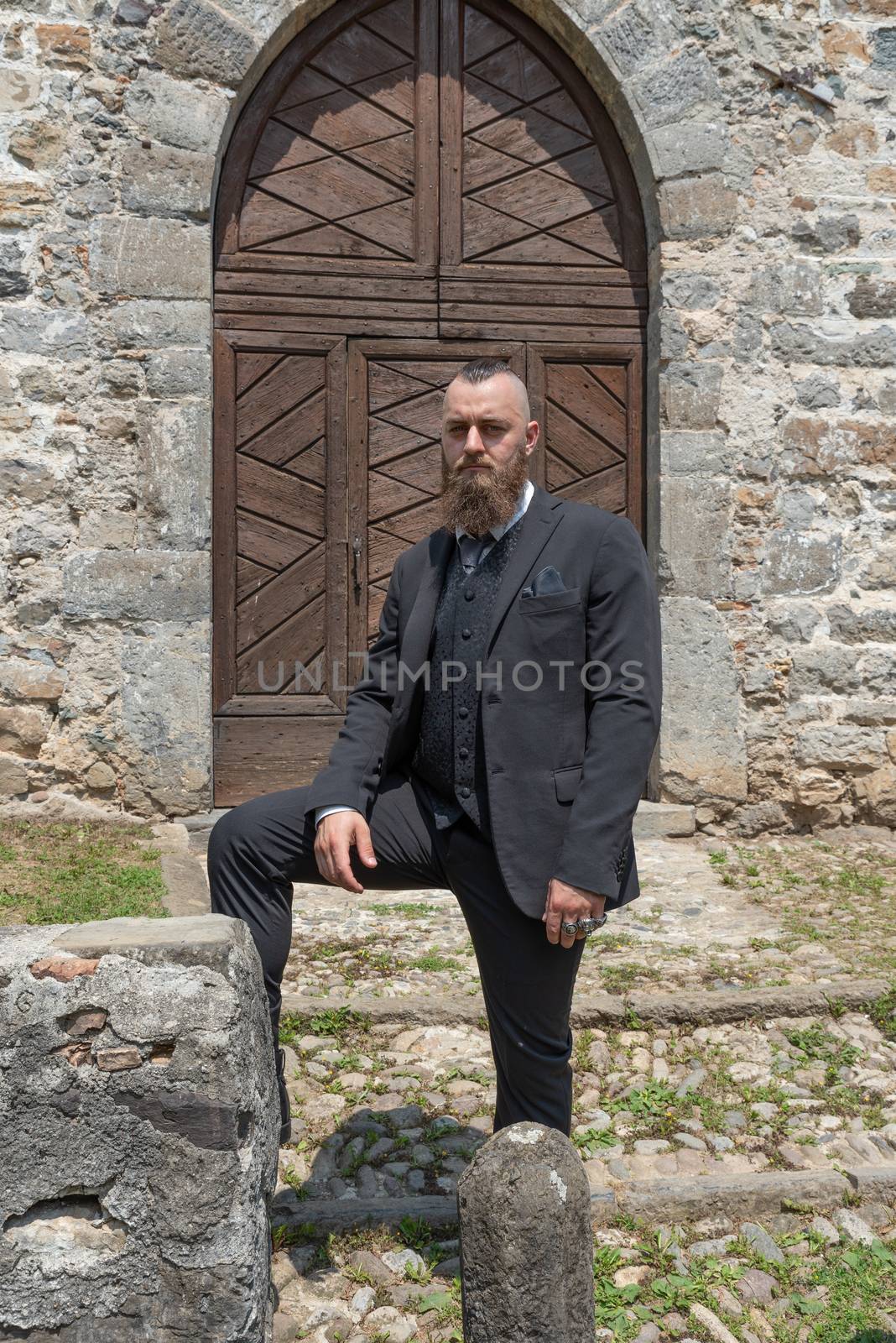 Groom waits for his future wife in front of the church