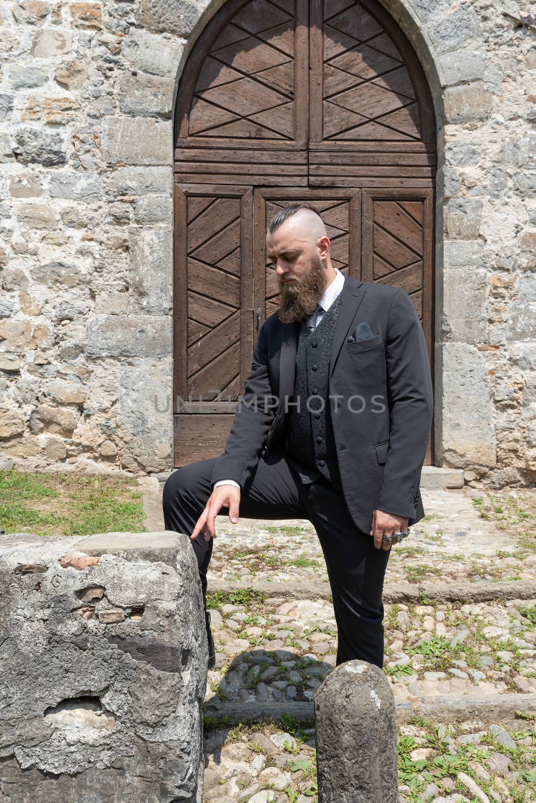 Groom waits for his future wife in front of the church