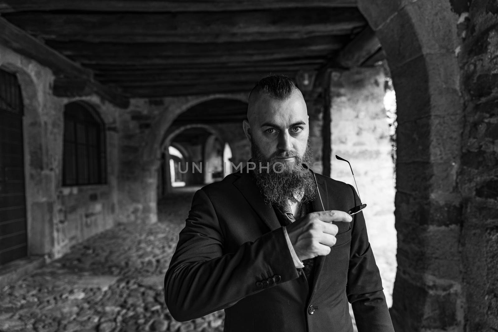 Man in elegant clothes with sunglasses by brambillasimone
