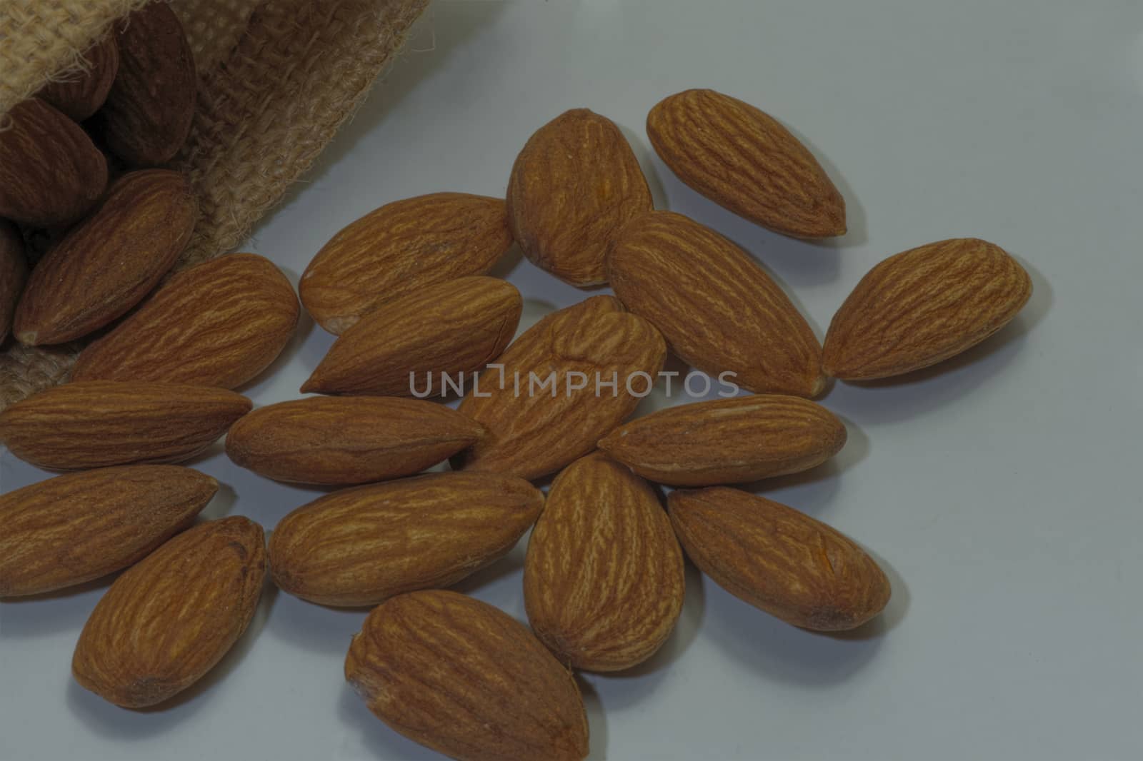 Close-up, almonds, placed together, white background.