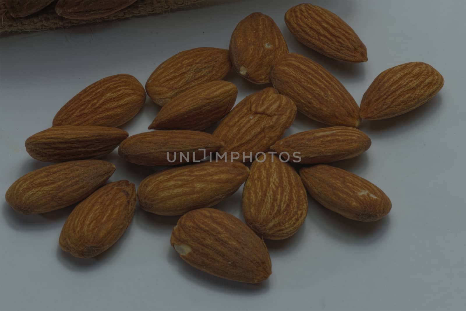 Close-up, almonds, placed together, white background.