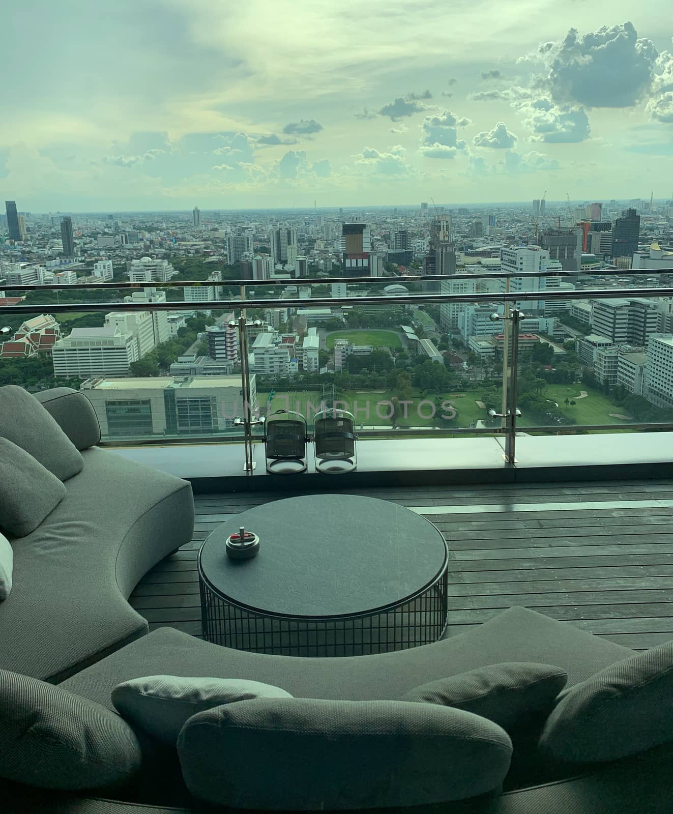 Relaxing sitting area with a view of tall buildings in the capital city of Bangkok.