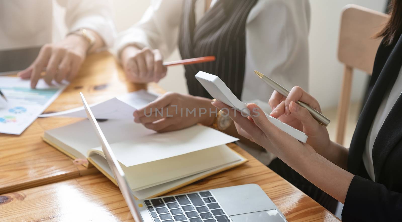 Close up Business people and partner using calculator and laptop for calaulating finance, tax, accounting, statistics and analytic research concept.