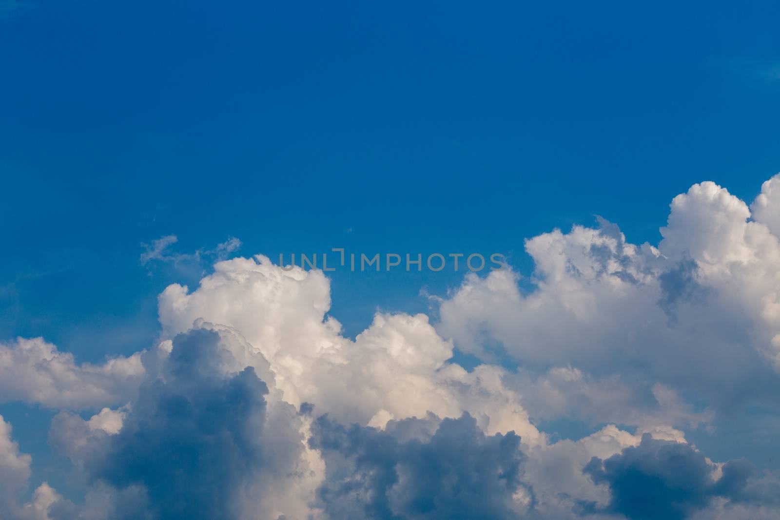 Regular summer afternoon clouds on blue sky at daylight in continental europe. Close shot wit telephoto lens