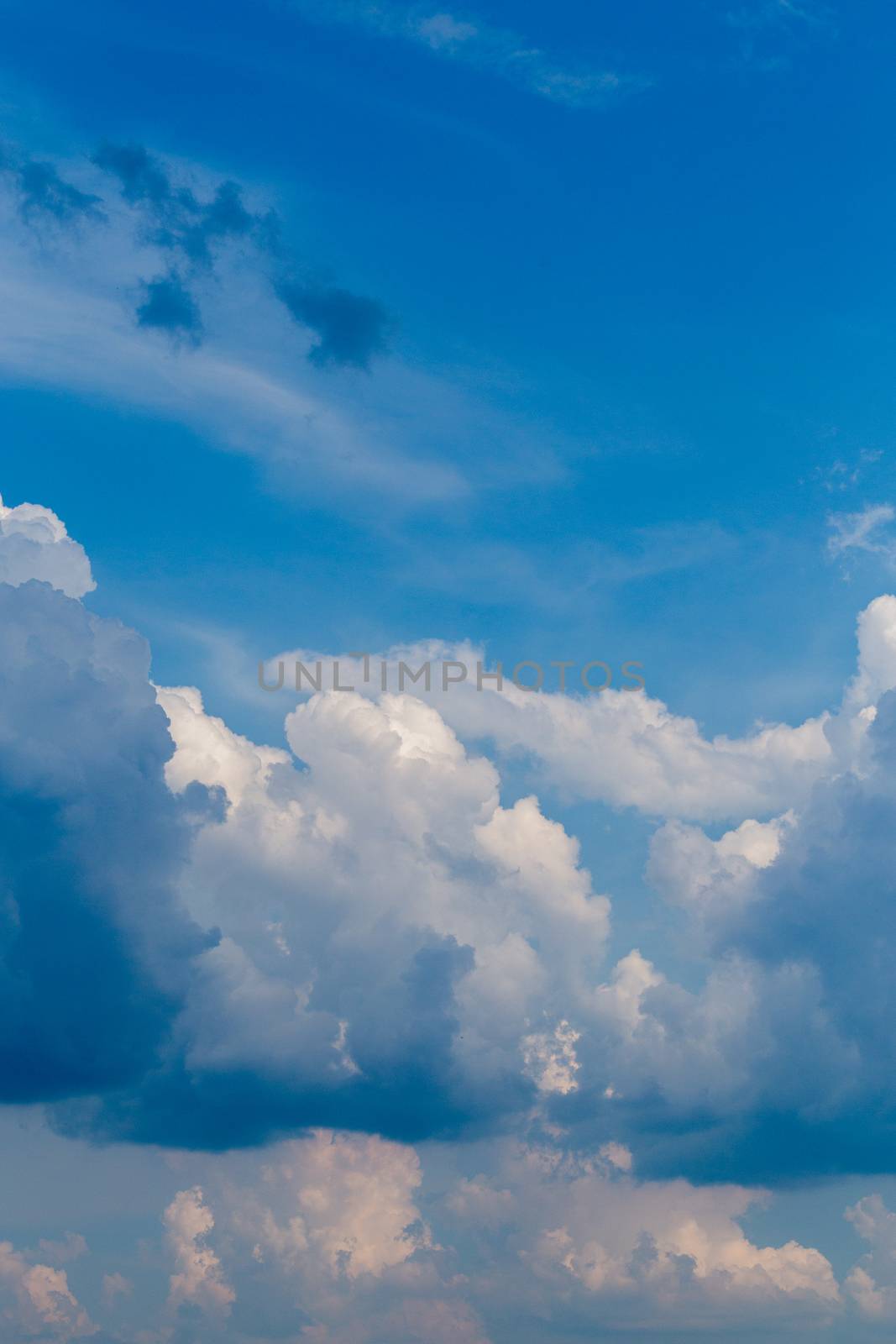Regular summer afternoon clouds on blue sky at daylight in continental europe. Close shot wit telephoto lens