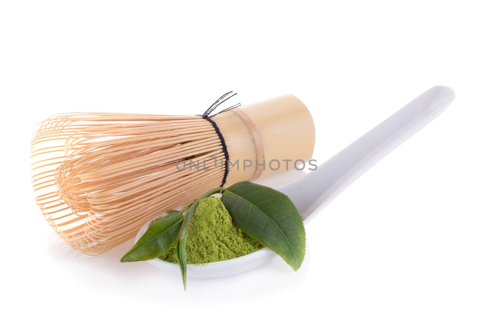 matcha powder in White ceramic spoon isolated on white backgroun by kaiskynet