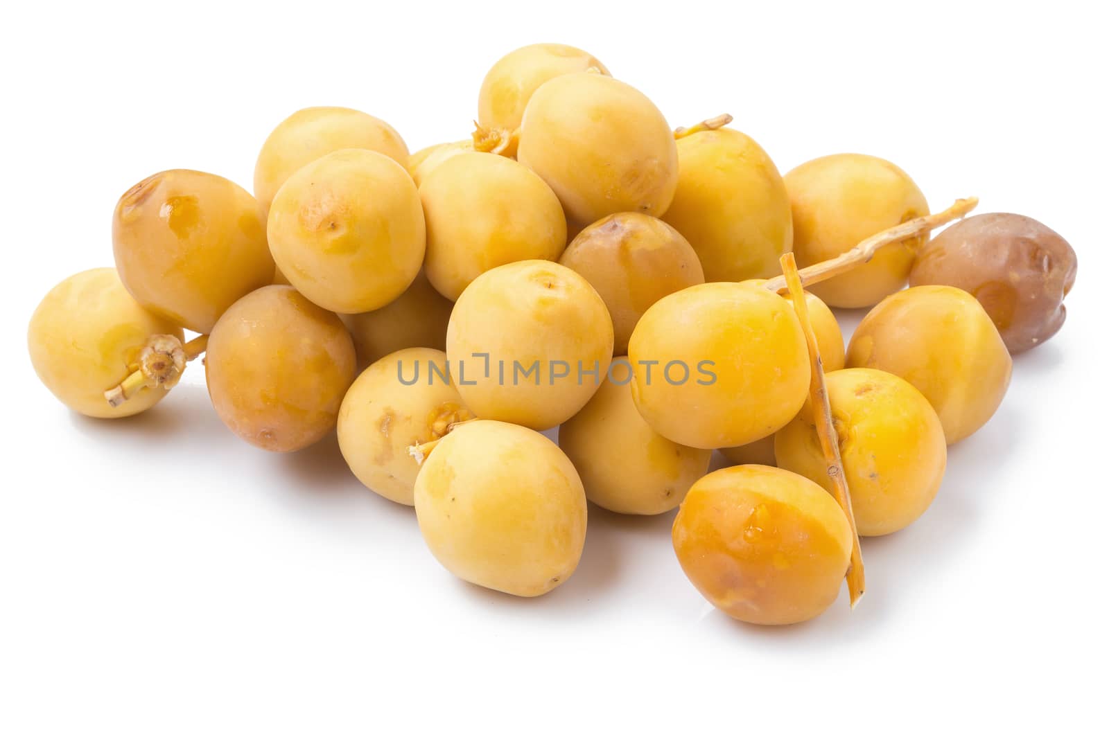 yellow raw dates isolated on white background.