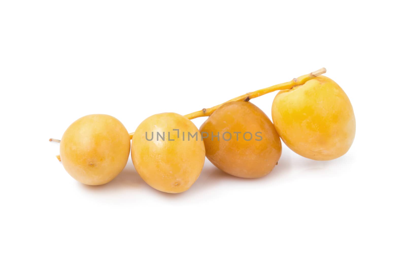 yellow raw dates isolated on white background.