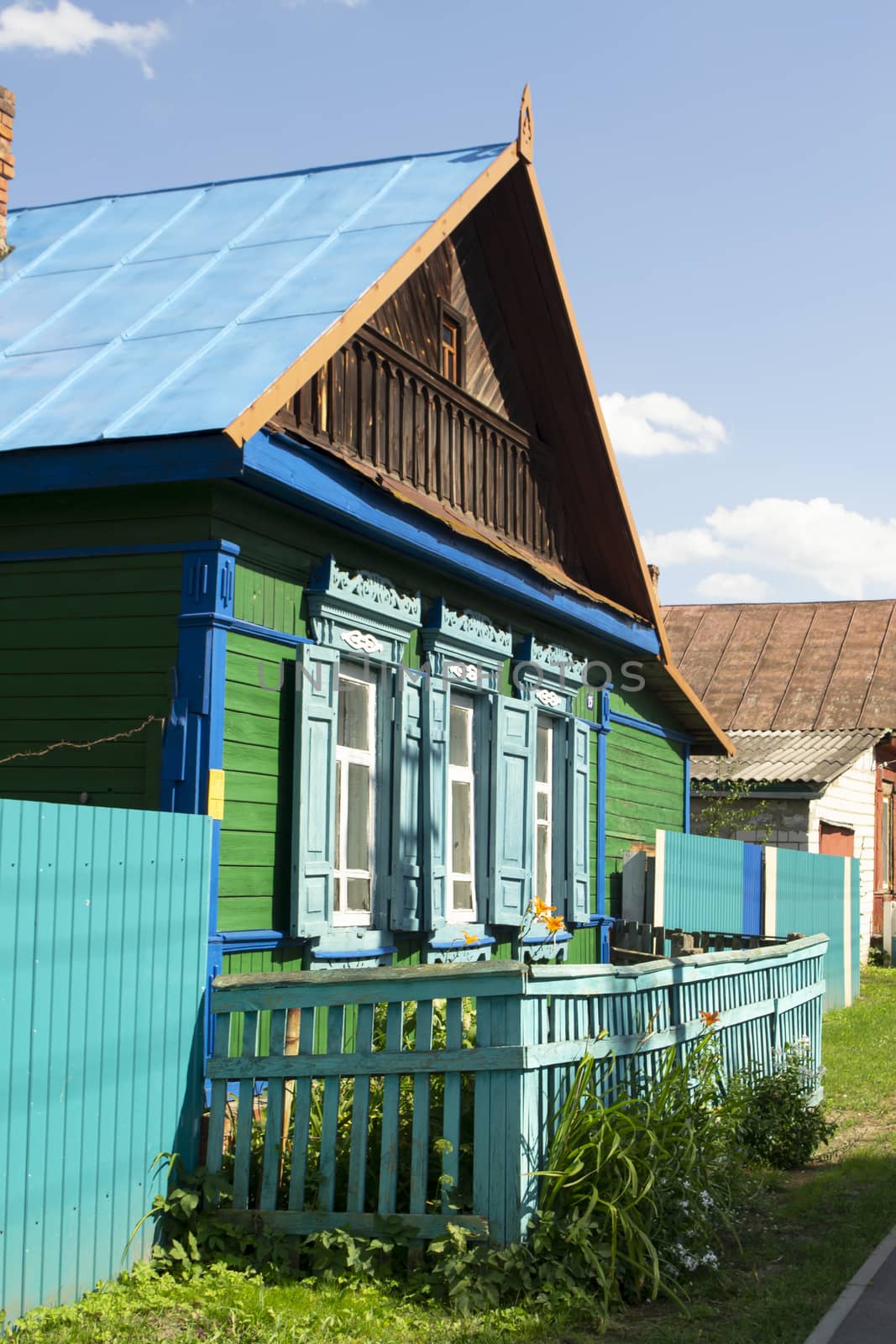 Old wooden traditional national rural house, decorated carved windows, frames in Belarus.